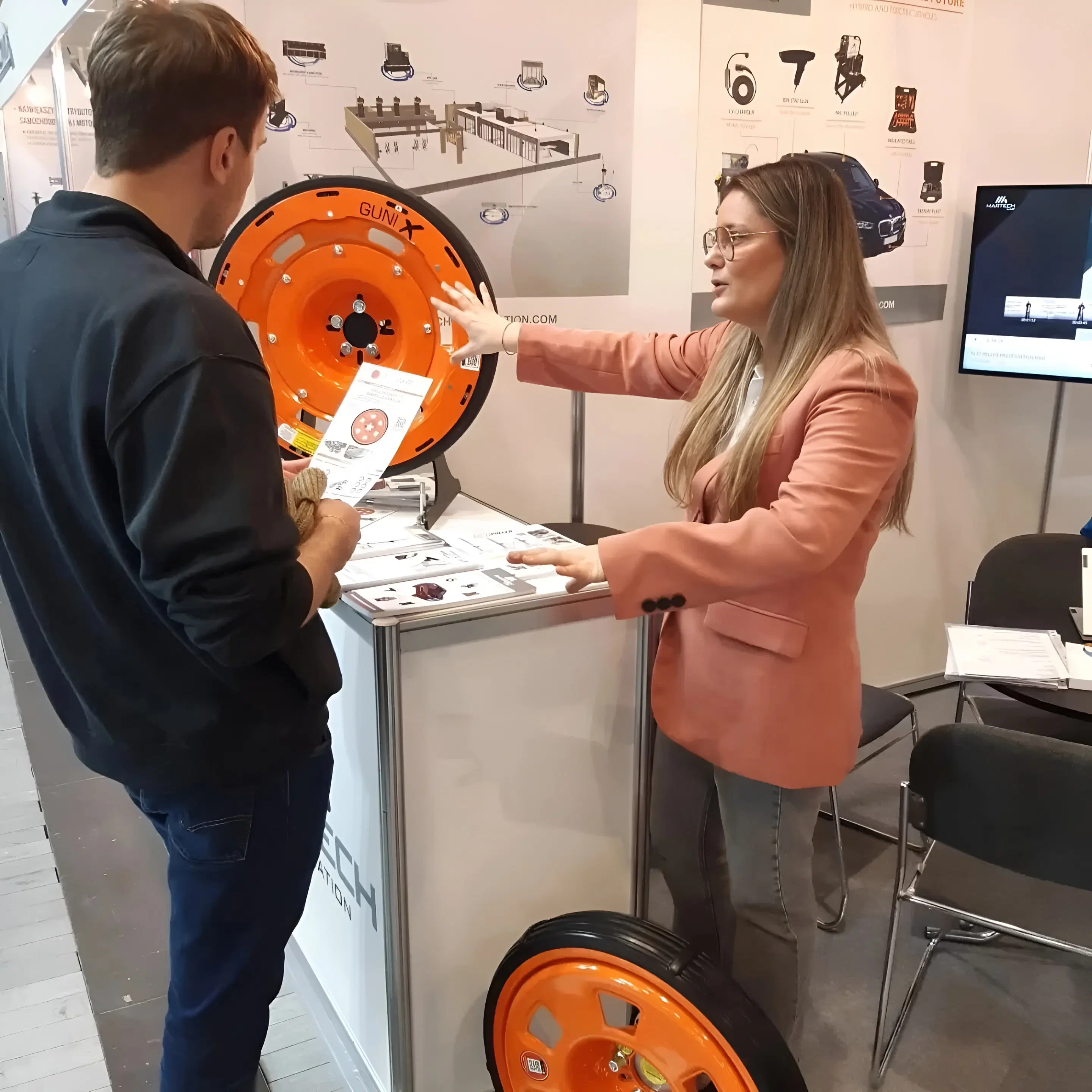 GuniWheel exhibition booth with representatives presenting the product