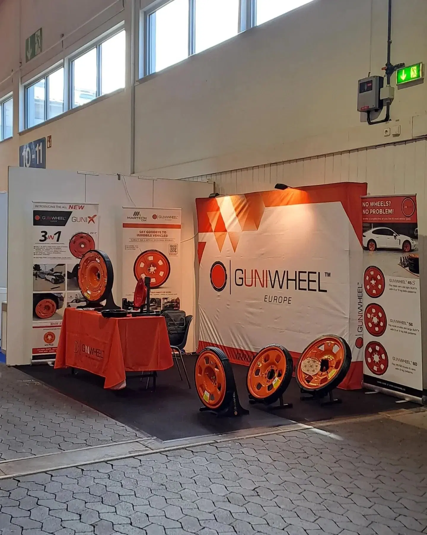 GuniWheel Europe display stand with orange wheels at trade show