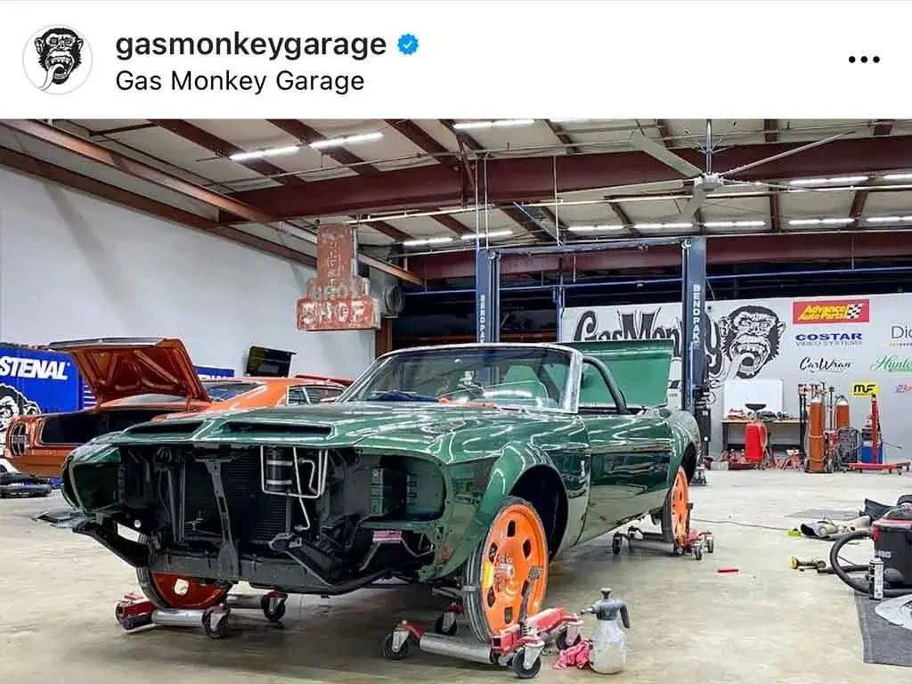Gas Monkey Garage workshop with green classic car on orange GuniWheel temporary wheels